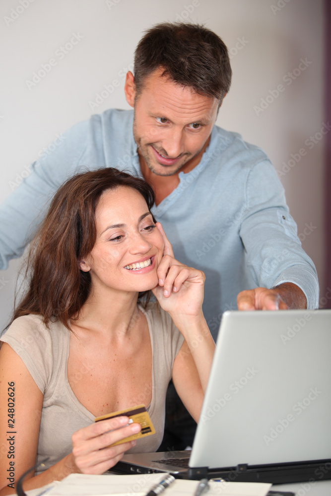Couple at home shopping on internet Couple at home shopping on internet