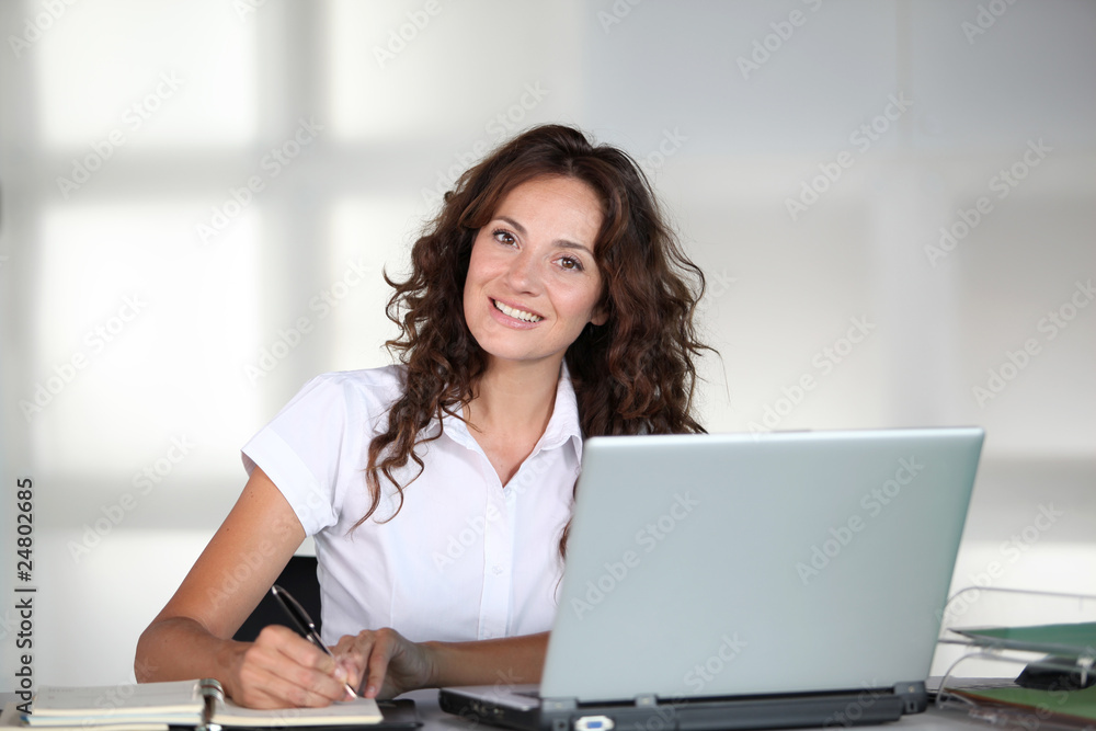 Businesswoman in front of computer in the office Businesswoman in front of computer in the office