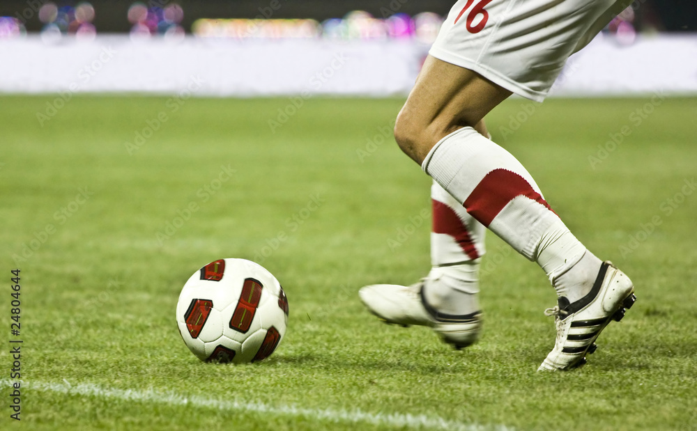 Soccer player running after the ball