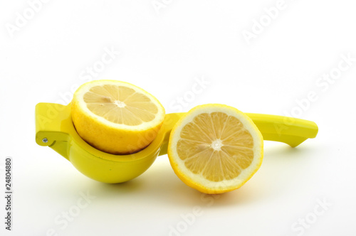 cut lemon with lemon squeezer isolated on white