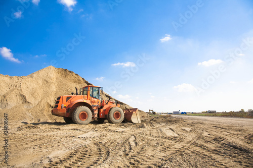 Orange excavator in a general construction scene