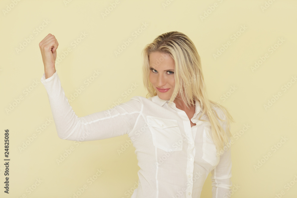 Young woman flexing her arm Young woman flexing her arm