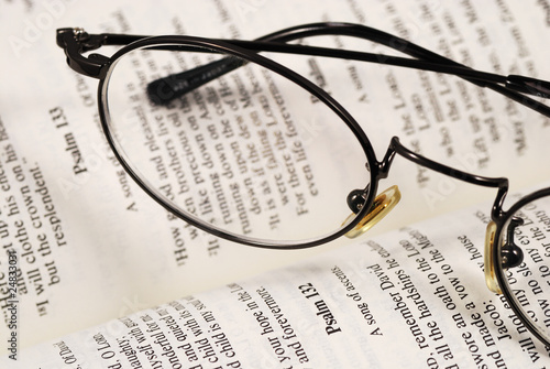 A pair of glasses on a book concepts of knowledge and education
