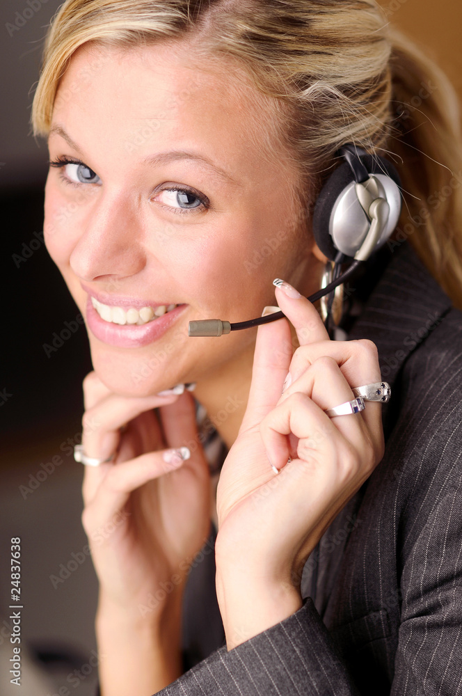 Atractive businesswoman in black two-piece suit with headphone Atractive businesswoman in black two-piece suit with headphone