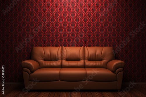 brown leather sofa in front of red wall