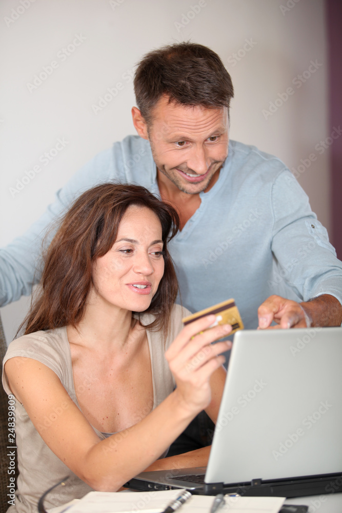 Couple at home shopping on internet Couple at home shopping on internet