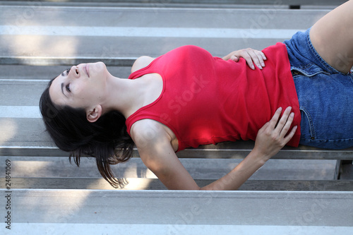 Φωτογραφία young latina teen girl reclining on bleachers