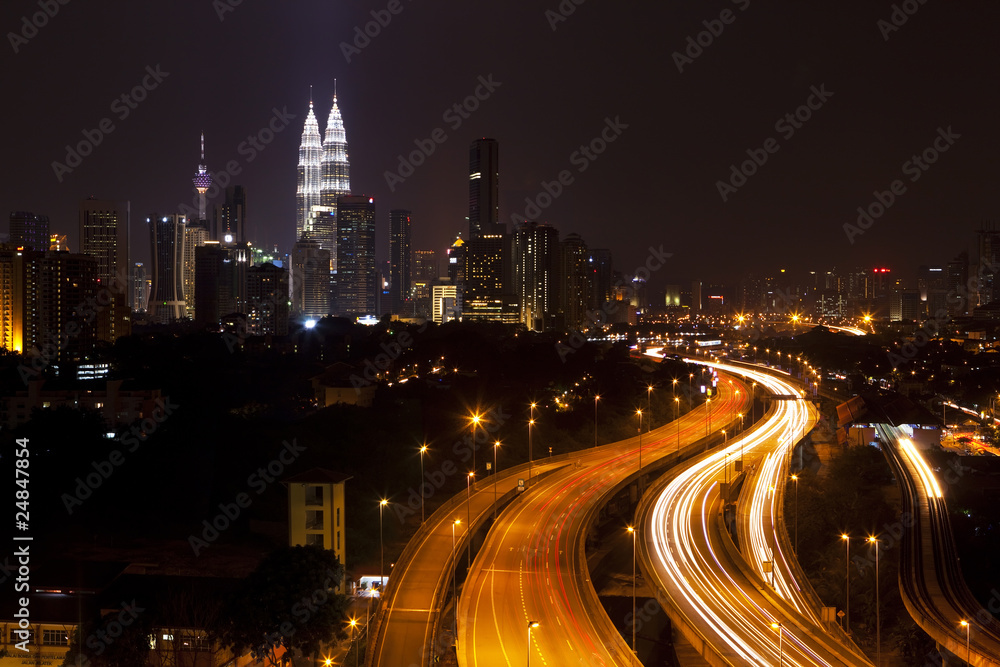 Kuala Lumpur cityscape, with Petronas towers illuminated.