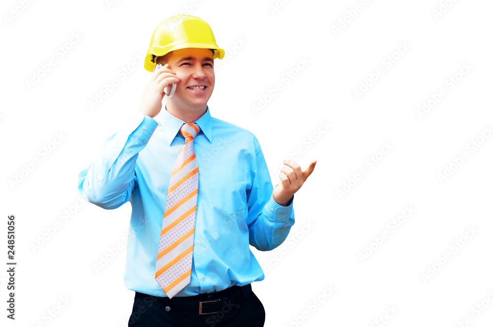 Young architect wearing a protective helmet standing on the buil Young architect wearing a protective helmet standing on the buil