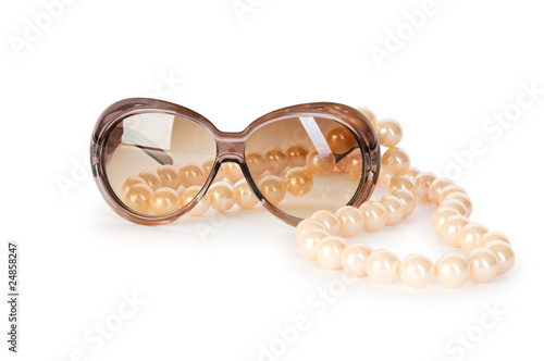 Pearl necklace and sunglasses isolated on the white background