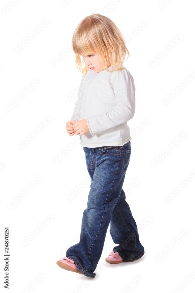 little girl wearing jeans and shirt is walking. isolated. little girl wearing jeans and shirt is walking. isolated.
