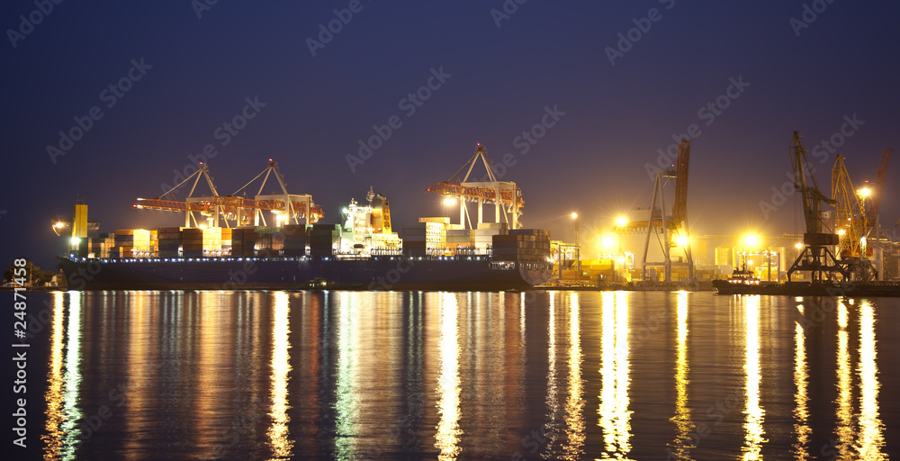 Cargo ship in the port at night