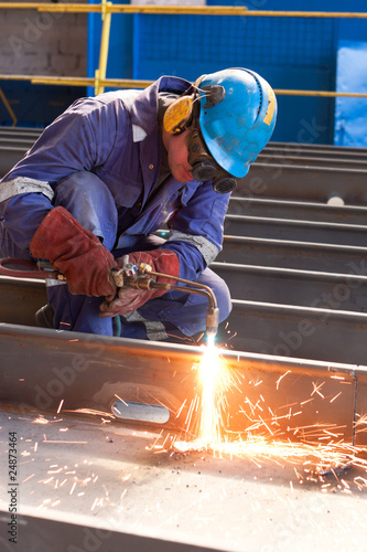 worker weld metal in factory and sparks