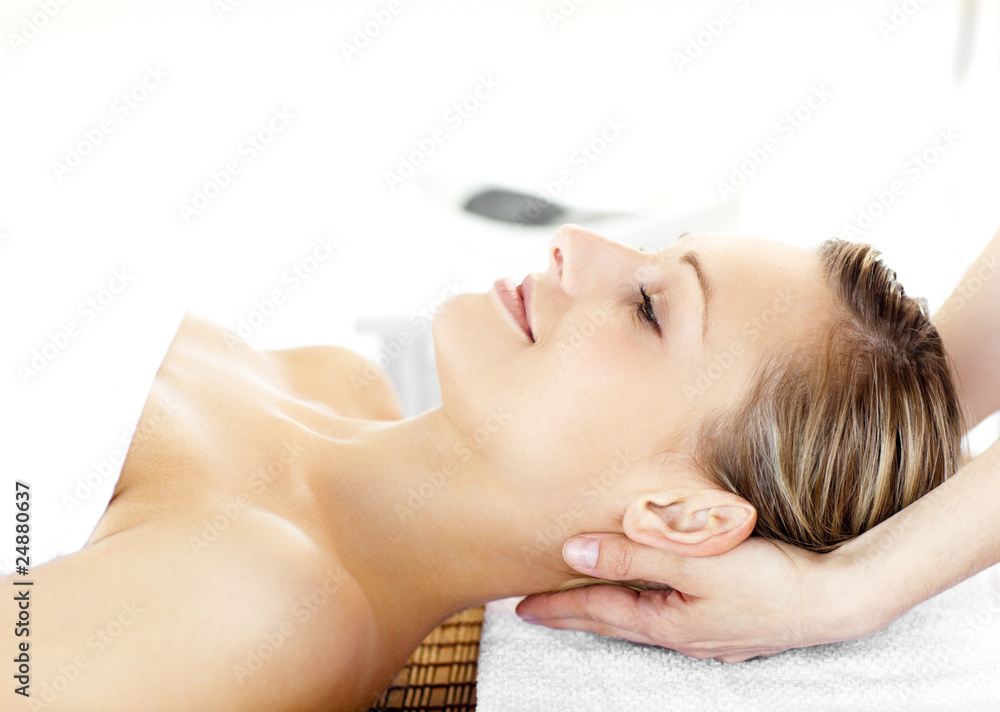 Glowing young woman enjoying a massage Glowing young woman enjoying a massage