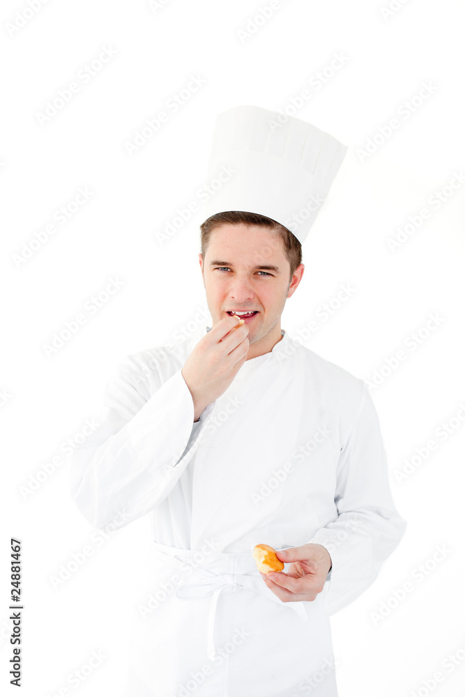 Smiling male chef eating fresh bread looking at the camera Smiling male chef eating fresh bread looking at the camera