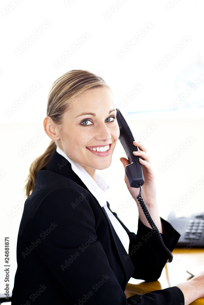 Pretty caucasian businesswoman talking on phone looking at the c Pretty caucasian businesswoman talking on phone looking at the c