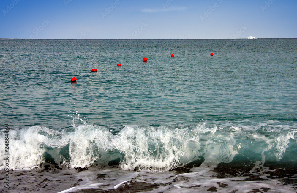 Surf and  buoys in the sea.