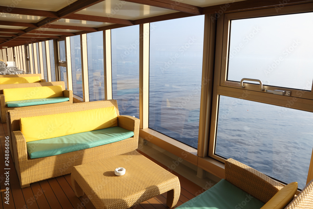 room for rest with sofas and tables near window in cruise liner