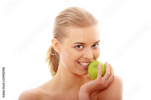 Beautiful girl eating green apple