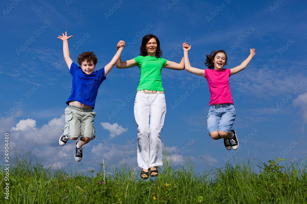 Active family - mother and kids jumping outdoor Active family - mother and kids jumping outdoor