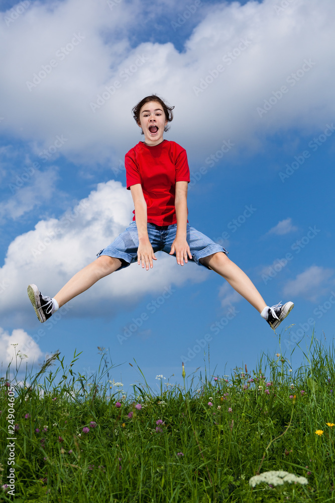 Girl jumping, running against blue sky