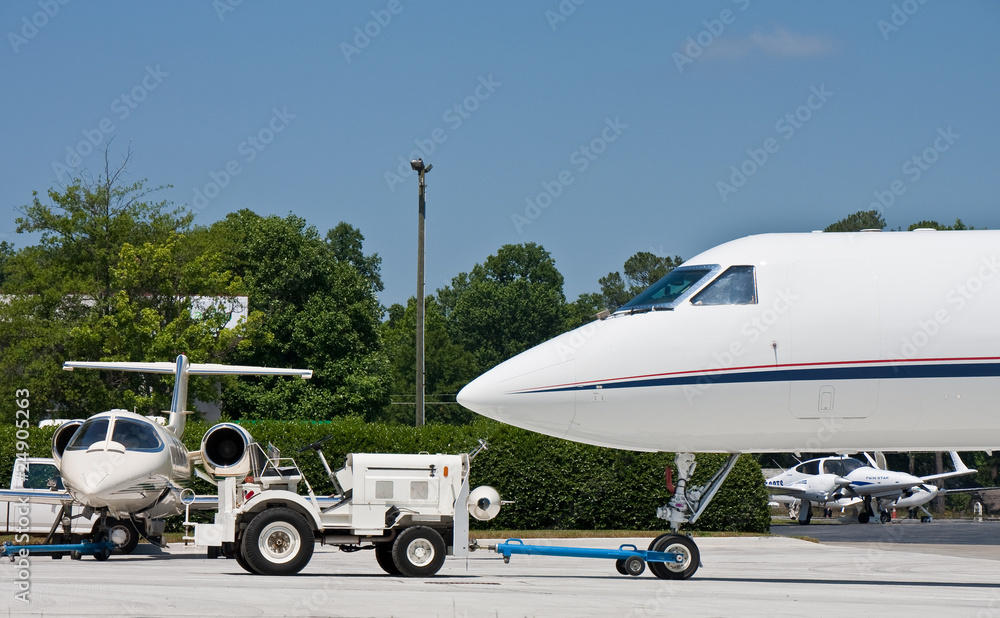 White Tractor Towing Private Jet White Tractor Towing Private Jet