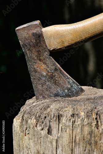 Old Lumberjack's Axe stuck in a chopping block closeup