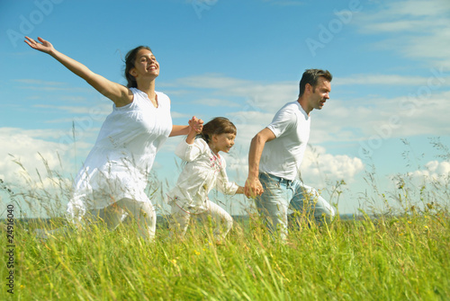 Happy family run on meadow