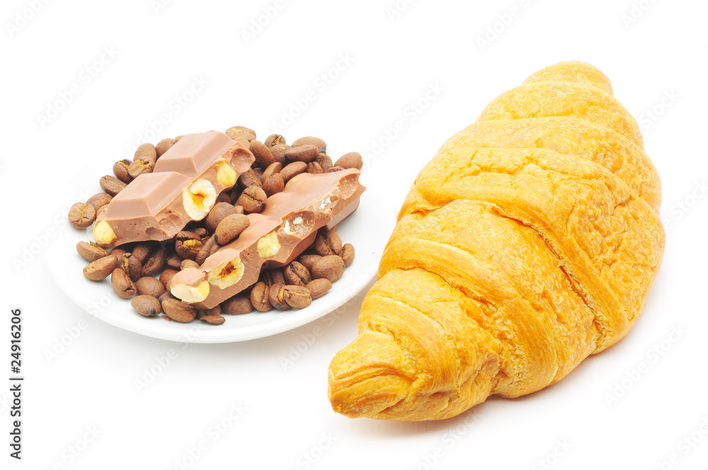 croissant and a plate with coffe beans and chocolate croissant and a plate with coffe beans and chocolate