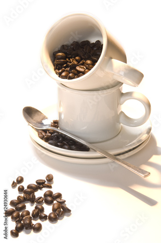 Cup coffee with beans in warm morning light