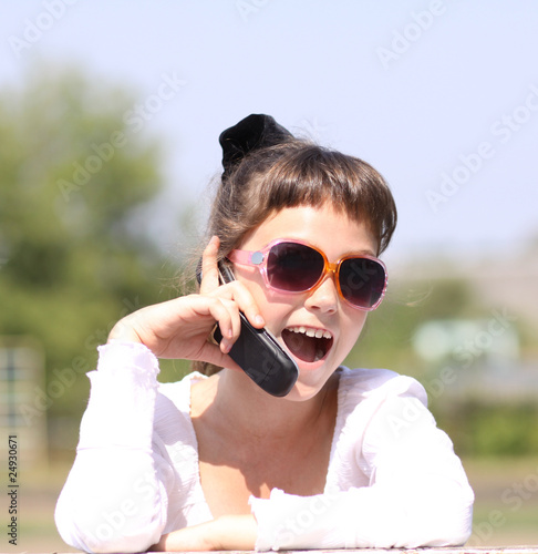 Beautiful little girl calling by phone