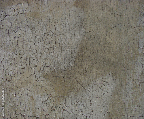 delicate soft crackled paint on a dirty gray brown worn wall