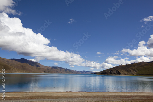 tibet: yamdrok yumtso lake with dramatic clouds © mamahoohooba