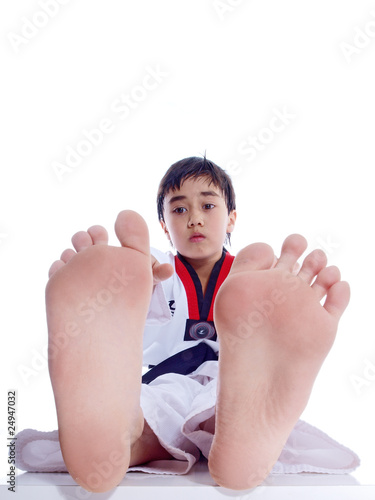 child exercising touching for his toes