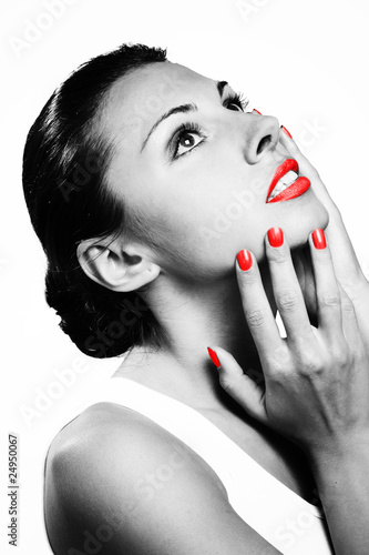 Monochromic portrait of beautiful woman with red lips and nails