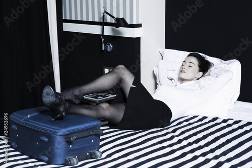 Woman sleeping in a hotel bedroom photo