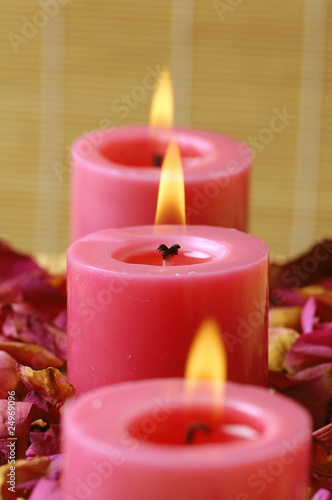 View row of candles with red rose petals