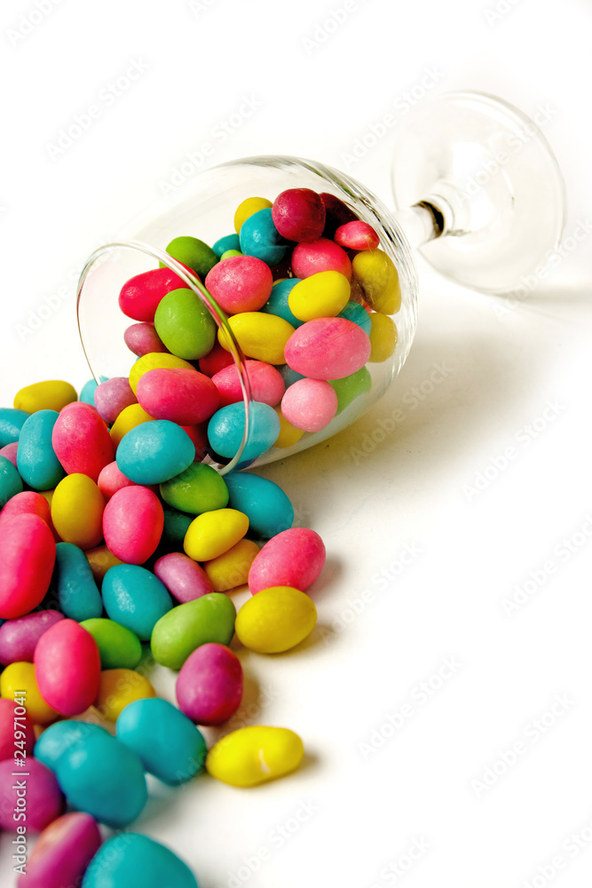 Color candie beans in glass on white background Color candie beans in glass on white background