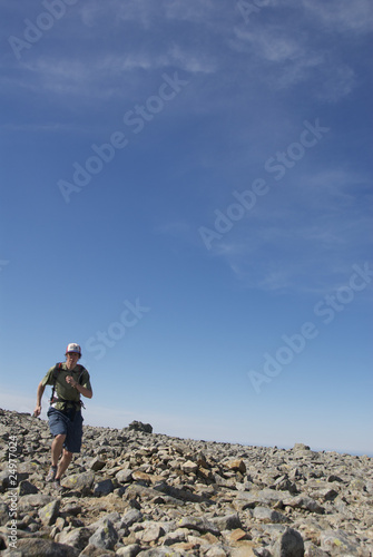 Man Trail Running on Rocky Mountain Peak