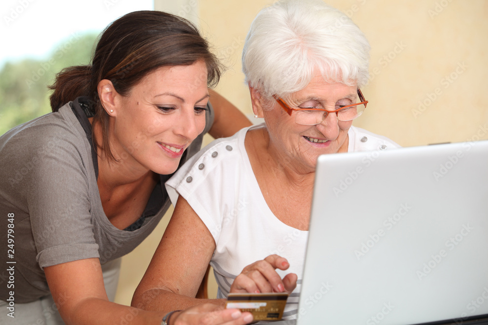 Elderly woman and young woman shopping on internet Elderly woman and young woman shopping on internet