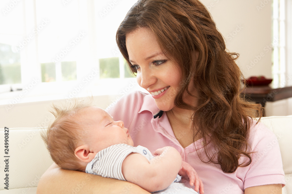Close Up Of Affectionate Mother Cuddling Baby Boy At Home Close Up Of Affectionate Mother Cuddling Baby Boy At Home