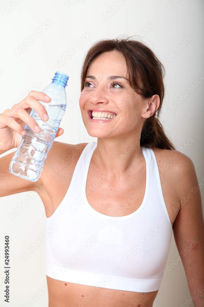 Closeup of woman drinking water after exercising Closeup of woman drinking water after exercising