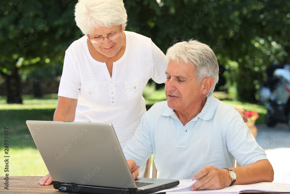 Senior couple using laptop computer at home Senior couple using laptop computer at home