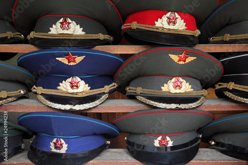 ussr polisman uniform hats with visor on wooden shelf photo