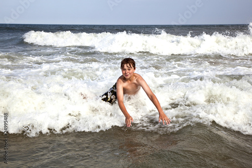 boy enjoys the waves of the ocean