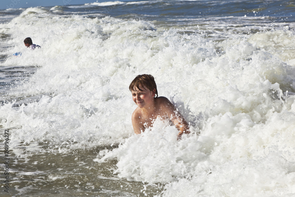 child has fun in the waves