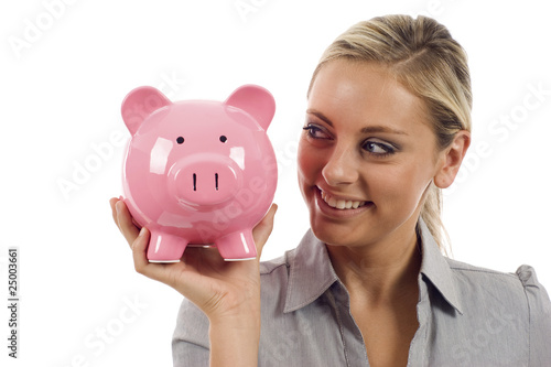 Smiling woman holding a piggy bank photo