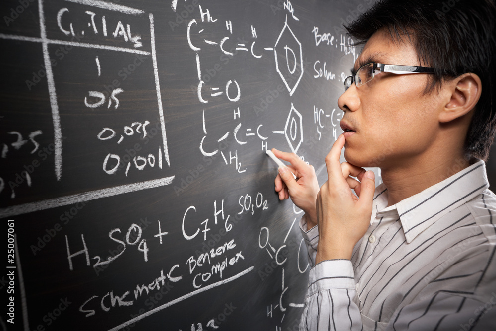 Fotografie Male student working on equation