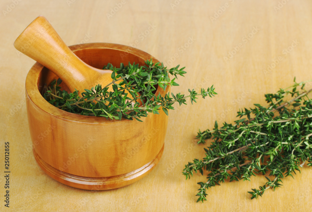 Fresh thyme with mortar and pestle (Selective Focus)