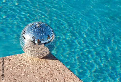 Disco ball beside resort swimming pool photo